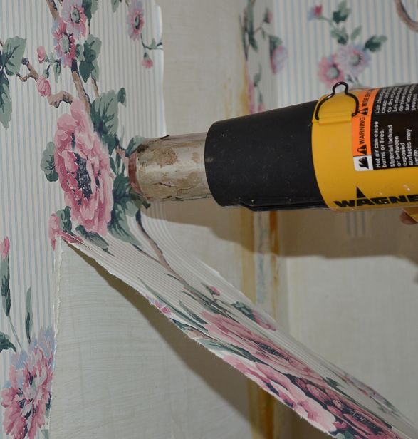 A heat gun or hairdryer can help to soften the glue to make it easier to strip wallpaper