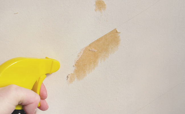 Spraying hard to remove remnants with warm water or remover solvents can help to prevent damaging the wall surface